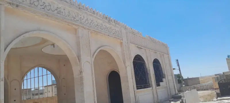 Calligraphy band and arches on the masjid façade